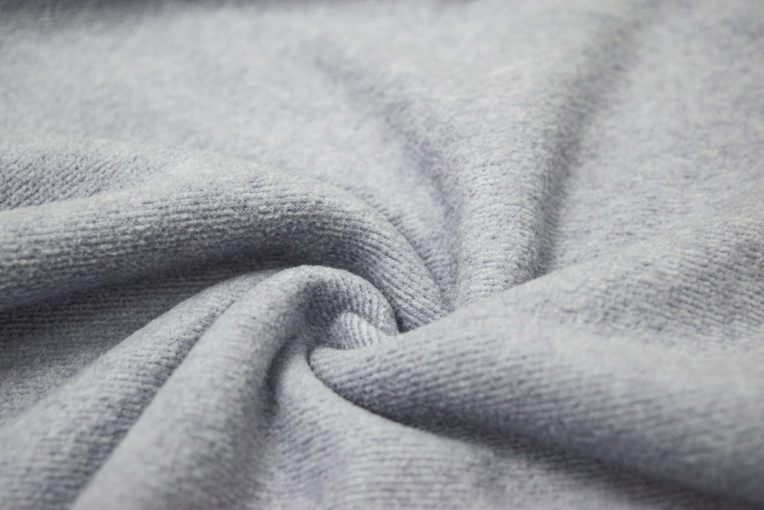 Close-up of brushed thermal knit fabric surface showing napped fiber structure