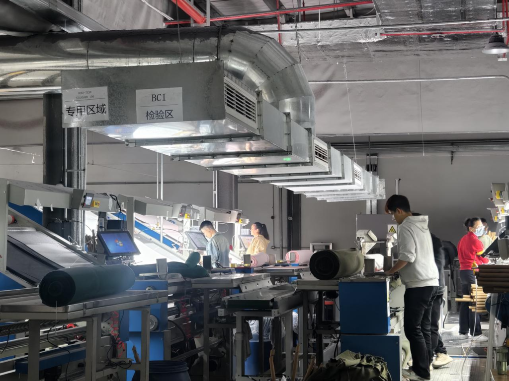 Workers inspecting fabric in a garment factory