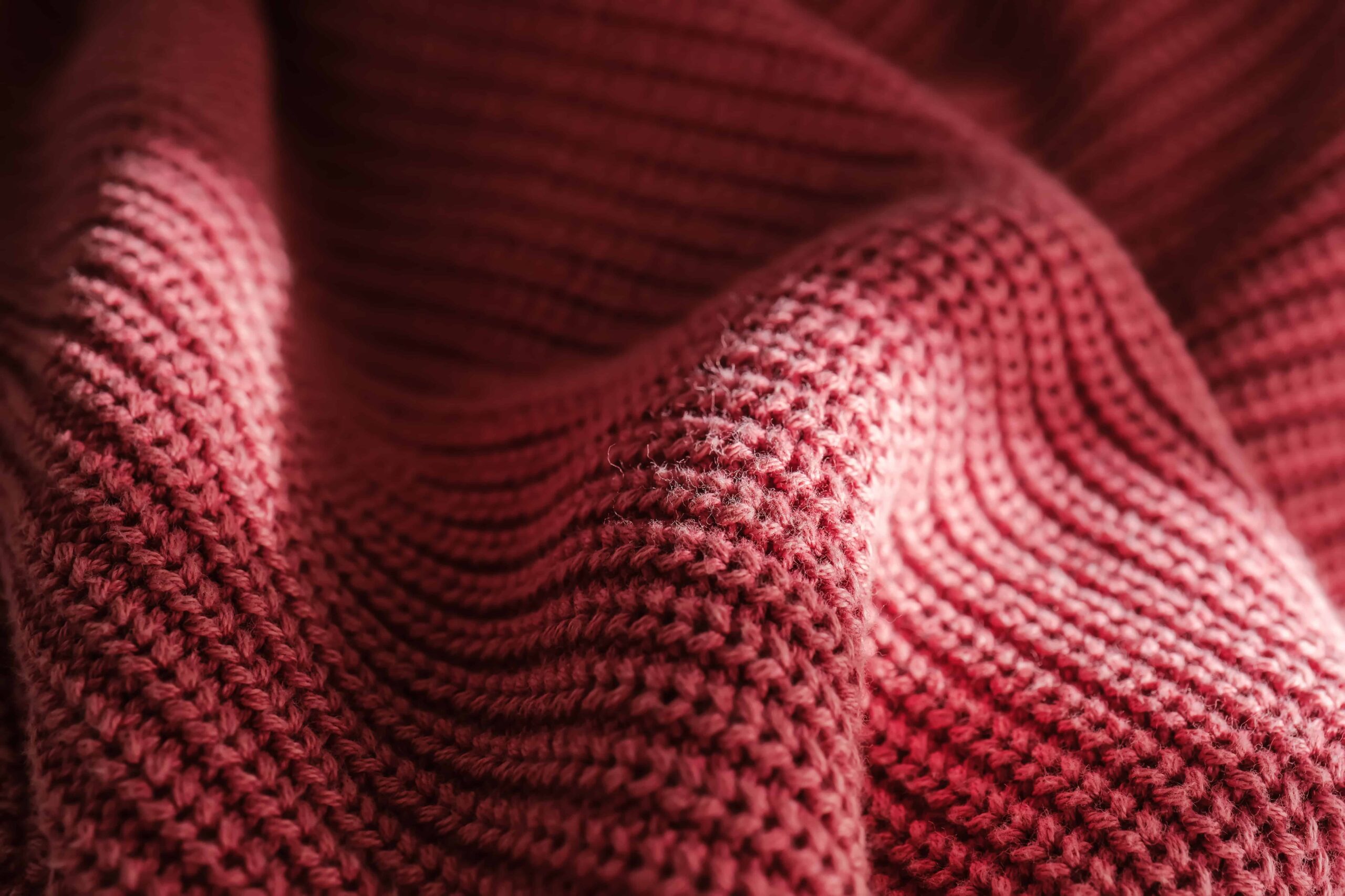 Close-up macro shot of performance knit fabric structure showing yarn interlacing