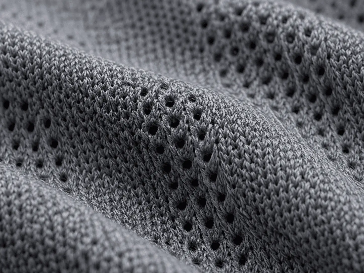 close-up of moisture-wicking knit fabric surface showing yarn structure