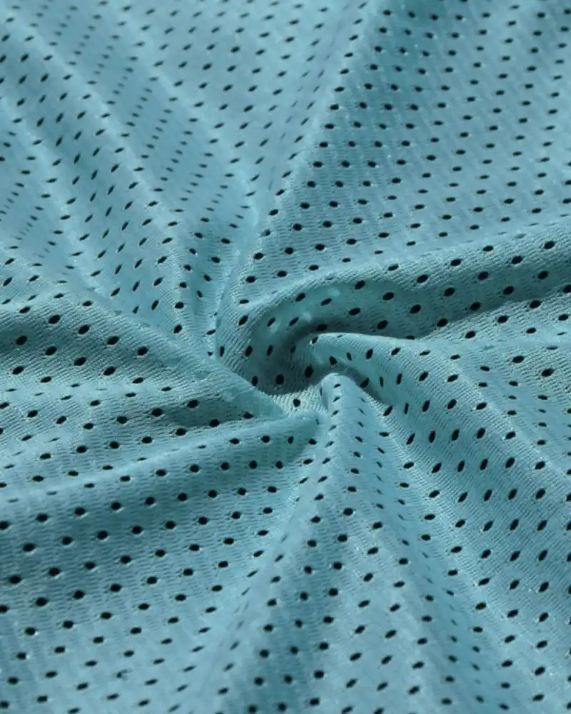 Close-up of breathable mesh knit fabric with open stitch holes