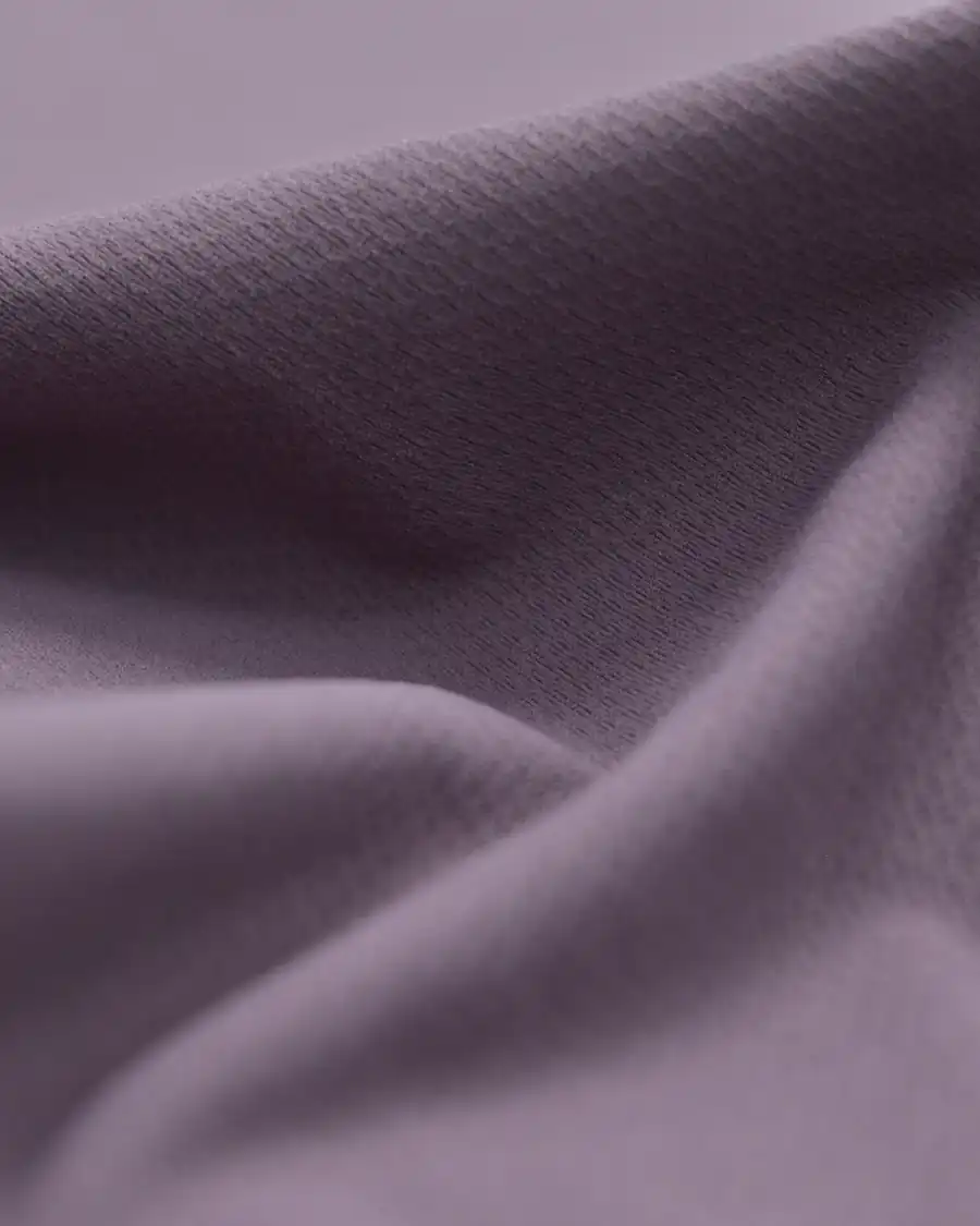 Lightweight performance knit fabric draped to show its soft, fine jacquard surface