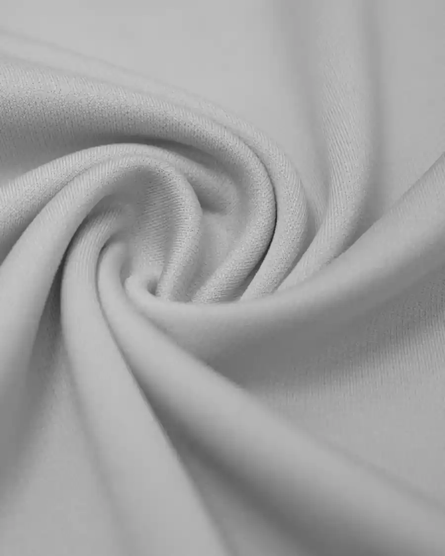Soft grey spandex-free stretch knit fabric draped in a swirl